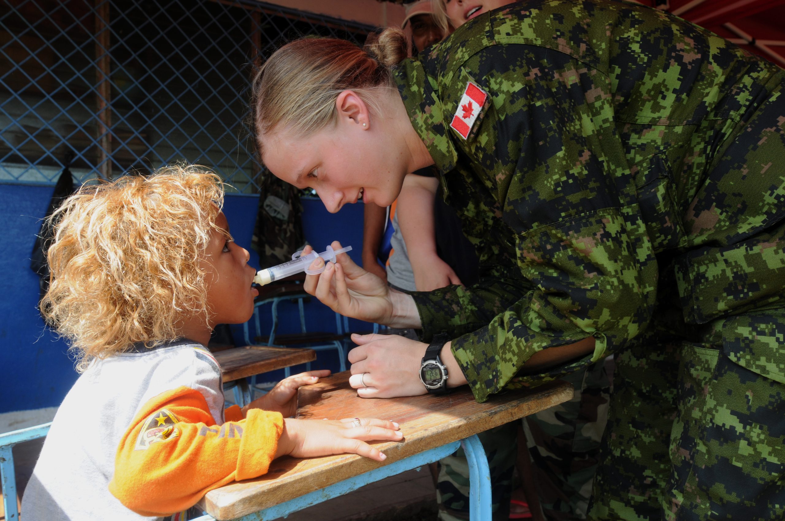 Tabitha Beynen, embarked aboard the amphibious assault ship USS Kearsarge, uses a syringe to give deworming medication into a child at the Betania medical clinic. (U.S. Navy photo by Mass Communication Specialist 3rd Class Christopher Lange)